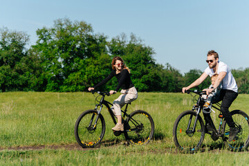 Fototapeta premium Family having great time, riding in a countryside, along trees and fields
