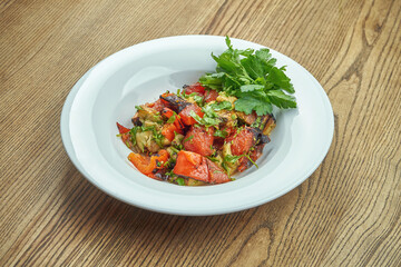 vegetable sauté of tomatoes, eggplant and bell pepper in a white plate. Veggie Stewed Vegetable Salad
