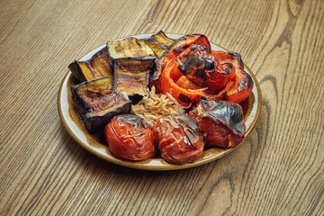 Freshly cooked vegetables on grill. Salad of tomatoes, eggplants and bell pepper. Barbecue.