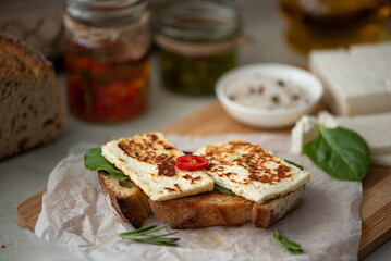 toasted piece of rye bread with feta cheese