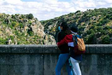 Two girls hugging each other in the nature
