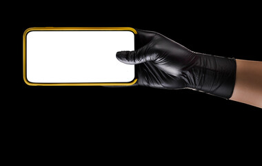 Hand in black glove holding mobile phone with blank screen isolated on black