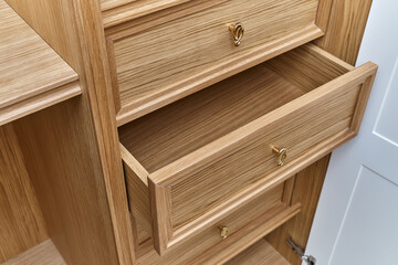 Wooden drawers of wardrobe close-up. Wooden wardrobe with wooden drawers and shelves. Wooden filling of wardrobe