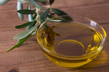 container of extra olive oil on wood
