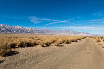Dirt road and the Sierra Nevada mountain next to the Nikkei concentration camp of Manzanar in Independence