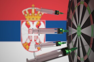 COVID-19 coronavirus disease vaccine syringes hit target against the Serbian flag. Successful research and vaccination in Serbia. 3D rendering