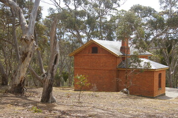 An old building set amongst eucalyptus trees in he Brisbane Ranges, Victoria, Australia.