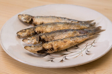 roasted or fried sardines on the plate