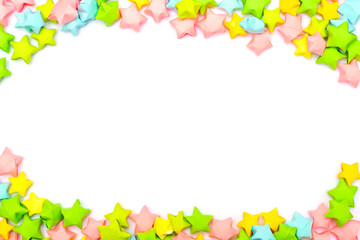 Frame of colorful paper stars in a children's style with an empty white place for text or image in the center