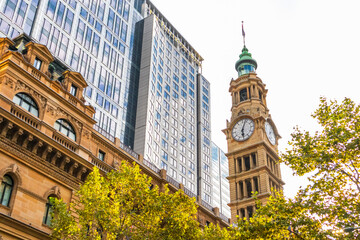 Sydney city centre. Tower clock and modern buildings. Picture from below. Sydney, Australia