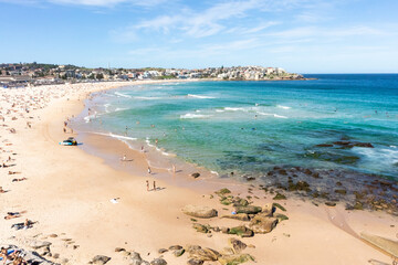 Sydney, NSW, Australia; March 2020: Bondi beach, famous urban bay in the city of Sydney, Australia. People sun bathing in summer. Turquoise water. Sydney, Australia