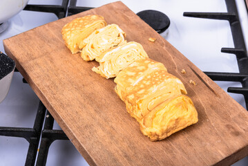 Tamago Japanese omelet on a wooden serving board, close-up