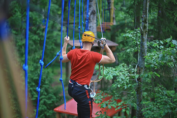 male climber rope park, outdoor activity training, guy, man extreme weekend in the forest