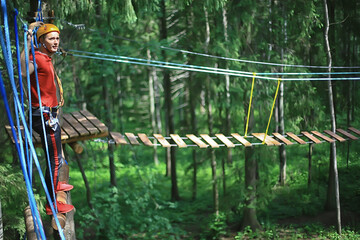 Fototapeta premium male climber rope park, outdoor activity training, guy, man extreme weekend in the forest