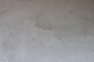 Textured of plastered cement wall is uneven and still wet for background.