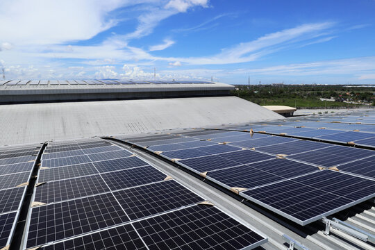 Solar PV Rooftop on Curve Roof under Construction Blue Sky Background