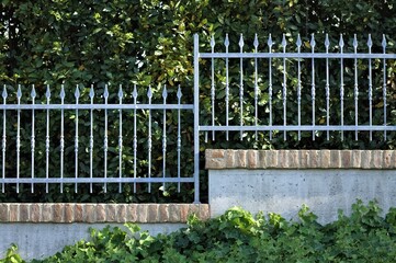 Metallic fence on a little brick wall (Pesaro, Italy, Europe)