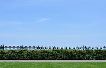 Metal fence on the coast, blue sky, sunny day