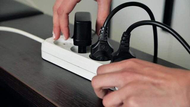 Hands unplug many adaptors from the electrical outlets and turn off electricity switch at home. 4k