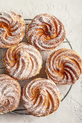 Closeup of muffins in powdered sugar on a textured background. Flat lay