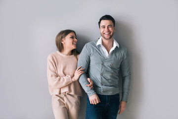 Portrait of married couple at home. Man and woman on a gray.