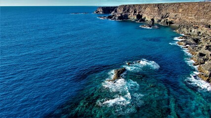 on the cliffs by the sea and the mountains watching the sunset