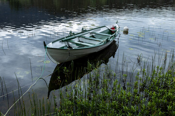White wooden row-boat on a lake © Tobben-PHOTO