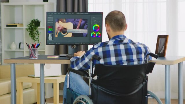 Invalid videographer in wheelchair working film post production from home office. Handicapped invalid paralysed freelancer, immobilized entrepreneur working from home, ilness and disability