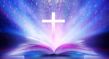 The Christian Cross is illuminated in a book in white and fantasy light, with magic shining as...