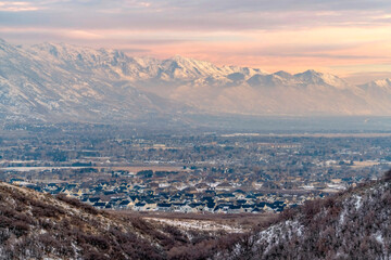Stunning Wasatch Mountains and Utah Valley with houses dusted with winter snow