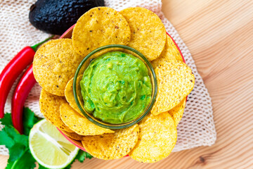 Mexican homemade Guacamole avocado corn nachos chip and tomato salad
