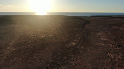 on the cliffs by the sea and the mountains watching the sunset