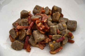 plate of gluten free buckwheat gnocchi, seasoned with crispy speck