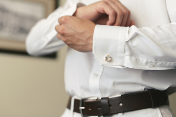 Men wear a shirt and cufflinks