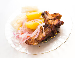 dish of fried pork ribs, rice, potatoes, sweet potato and pickled onions