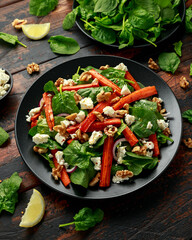 Roasted carrot salad with feta cheese, walnut and spinach. healthy food
