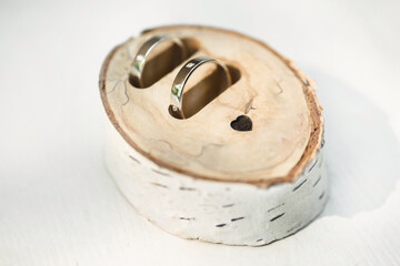 Wedding rings in a box made of birch wood with initials