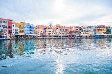 Fototapeta na wymiar Crete island of Greece, Chania bay with old town view. Cloudy day and colorful buildings, architecture. 