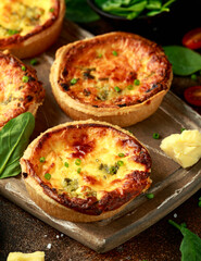 Cheddar cheese and spring onion omelette tarts served on wooden board with side salad. Healthy breakfast food