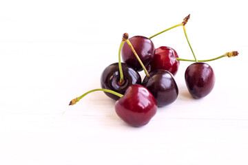 Obraz na płótnie Canvas Cherry berries on a white background. Fresh cherries. The concept of a healthy diet and support for local producers. Close-up. View from above. Copy space. Flatlay.