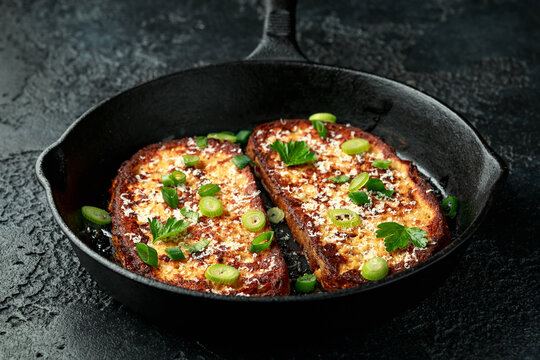 Parmesan cheese French Toast with spring onion on cast iron pan