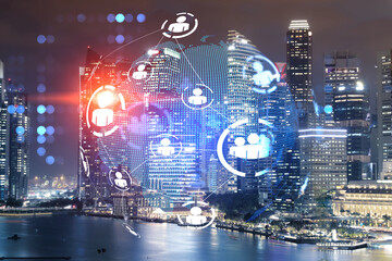 Glowing Social media icons on night panoramic city view of Singapore, Asia. The concept of networking and establishing new connections between people and businesses. Double exposure.