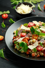 Mini potato gnocchi tricolour with tomato, spinach, Seasonal salad leaves and parmesan cheese
