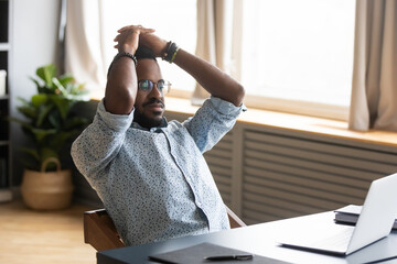 African man with inner tension feels nervous wait for important e-mail search solution sitting at...