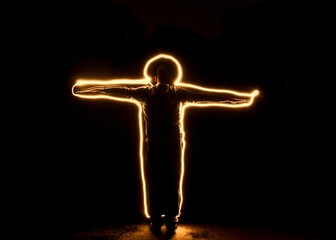 Jesus cross human light trails fireworks in the night