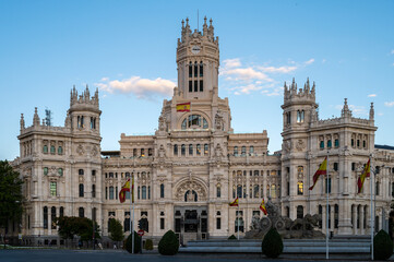 Fototapeta na wymiar Facade of City Hall and Cibeles statue in Madrid, Spain. Spanish flag waving.