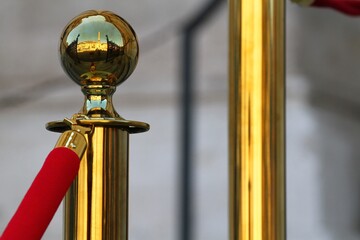 Brass stanchion with red velvet rope. The knob reflects Piazza Navona in Rome