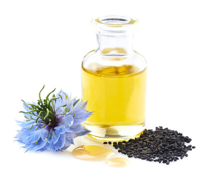 Black cumin oil with seeds on white background