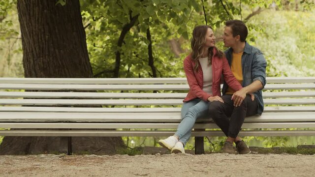 Young, happy, loving couple having date in the park. Relations, friendship and love concept.