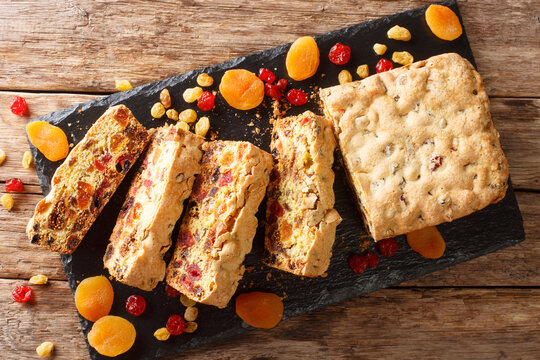 Healthy food fruit cake with dried apricots berries raisins figs cherries closeup on a slate board. horizontal top view